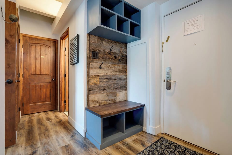 Your thoughtfully designed entryway welcomes you with custom storage cubbies and rustic wood details, keeping your belongings organized in style.