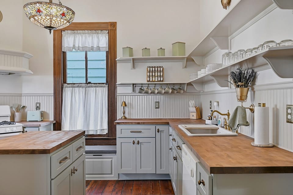 Spacious and bright Kitchen with brass accents. You'll love the window seats!
