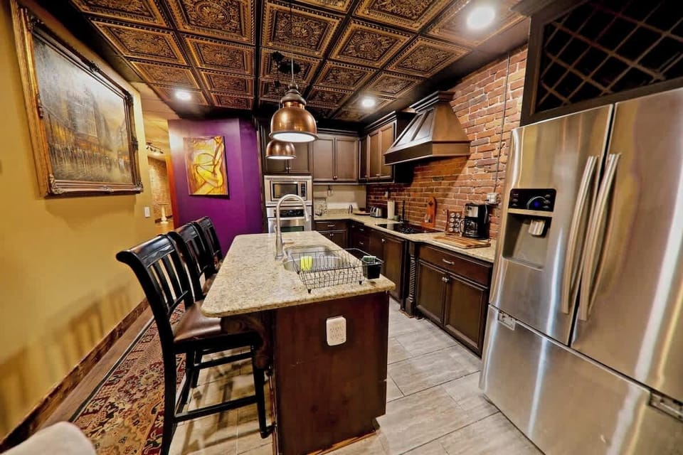  Top oven,  bottom microwave and a 4-burner cooktop to  pair with dishwasher, disposal, and fridge/freezer. The cabinets feature soft pull drawers and this space is available as eat-in bar seating for four.  The outlet makes for a great work space.