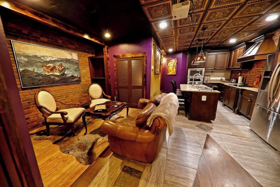 View from the grand bathroom showcasing the lounge area and the full kitchen.