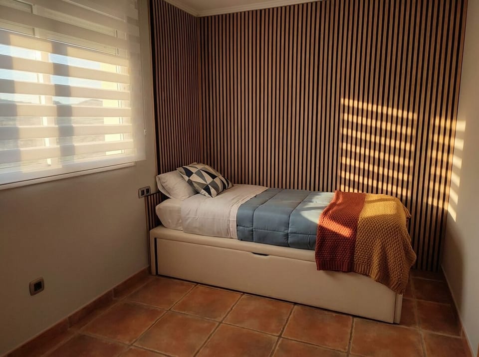 Cozy Bedroom with Striped Accent Wall