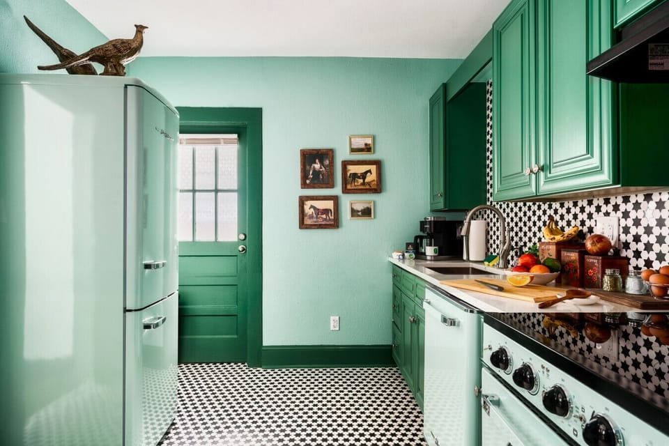 Functional vintage-style appliances, bold black-and-white backsplash, and modern amenities for cooking!