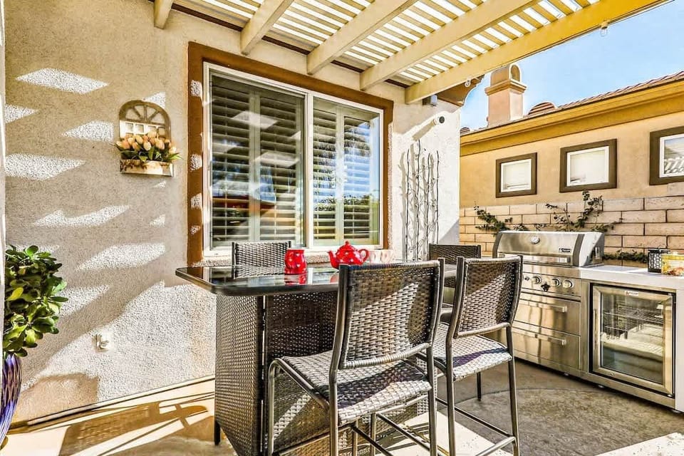 Outdoor Kitchen & Bar: Covered outdoor kitchen with BBQ, refrigerator, and bar seating—perfect for poolside dining and entertaining.