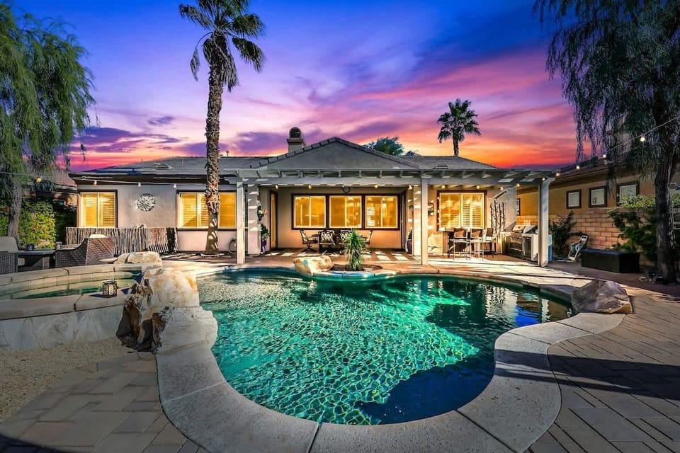 Pool at Sunset: Private resort-style pool surrounded by palms, with beautiful desert sunset views.