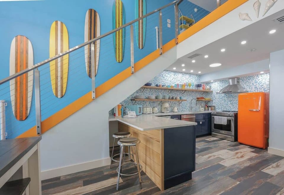 Perfect for coffee, cocktails, or quick bites the two-seat breakfast bar keeps everyone connected while you cook in this colorful, high-end kitchen.”