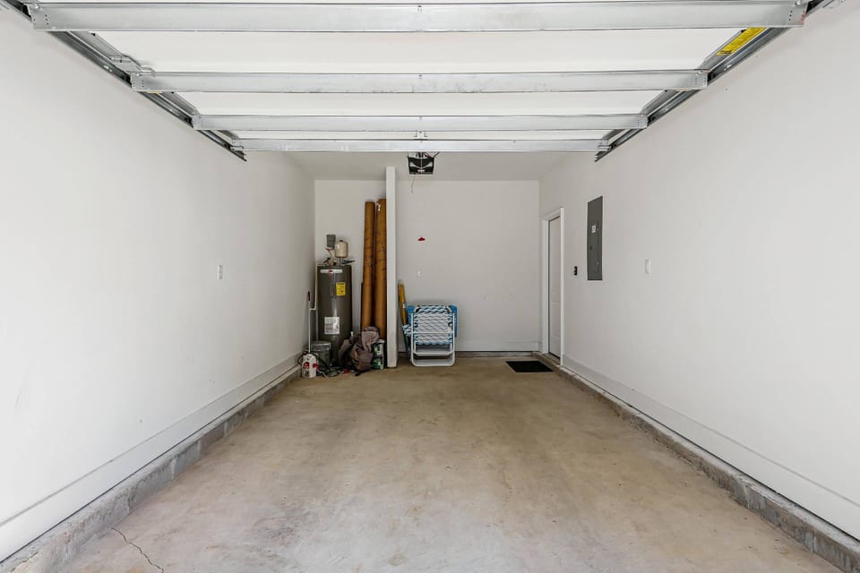 Single car garage available with beach chairs and umbrella