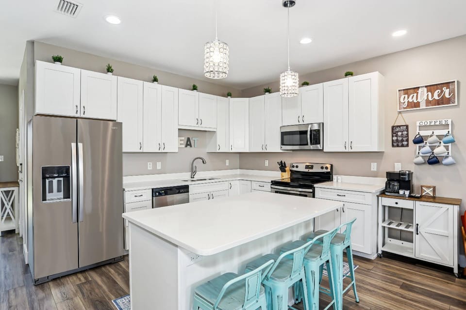 The kitchen boasts stainless appliances and quartz counters