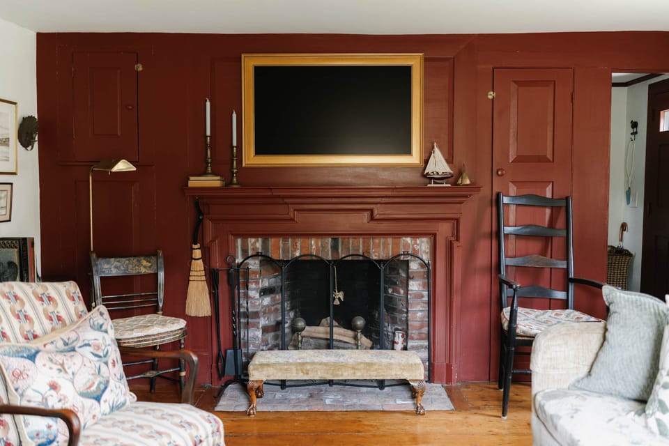Cozy living room with beautiful historic features, antiques, and amenities, including smart TV.
