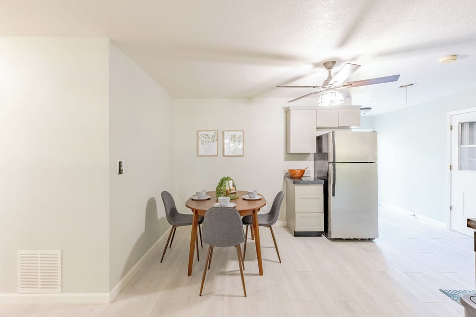 Bright kitchen featuring a cozy table set for four guests.