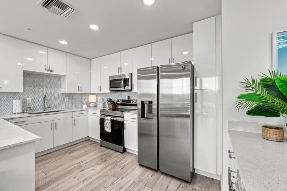 Whip up fresh seafood or pour your morning espresso in this sleek, stainless-equipped kitchen with island seating.
