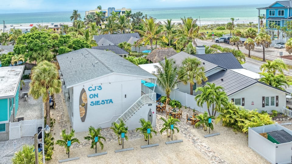 The CJs on Siesta Building with the Beautiful Coast in the Background