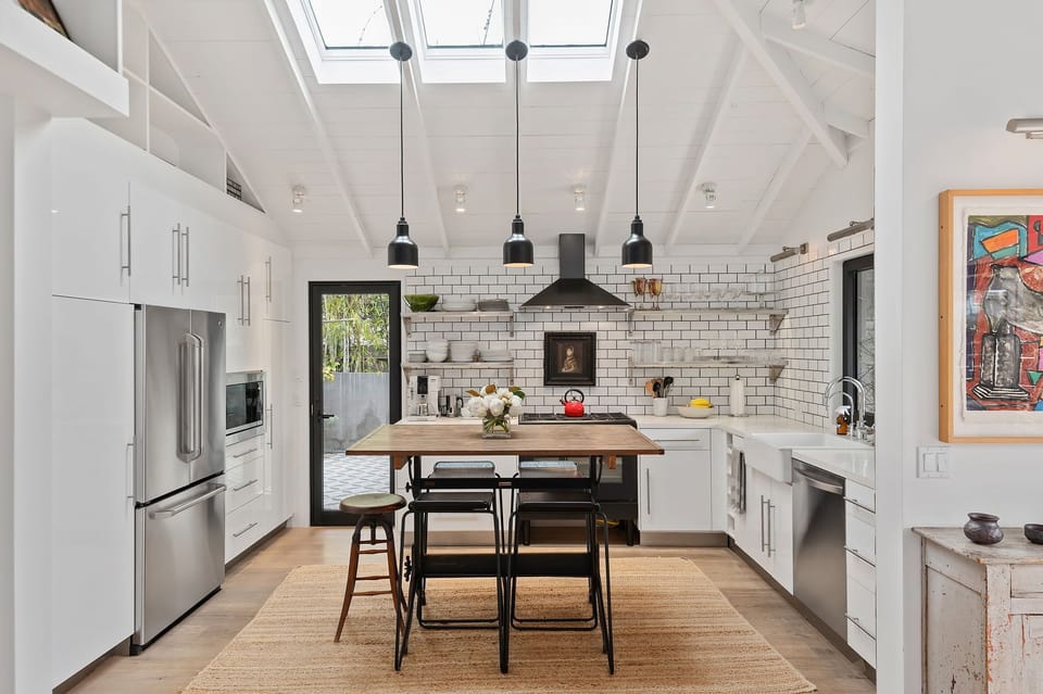 Charming kitchen with farm sink, stainless steel appliances & kitchen island.