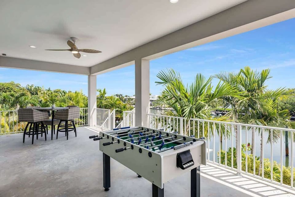 Upper Patio with Foosball, Dining table and Sitting area with gorgeous waterfront views