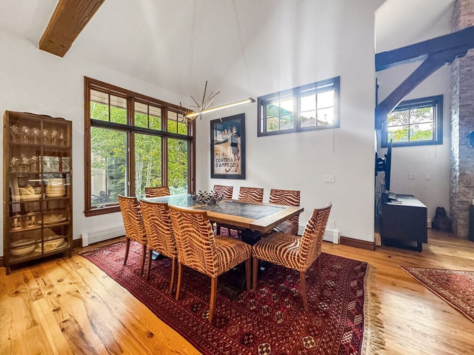 Gather your entire group around this elegant dining table bathed in natural light. Eight comfortable chairs ensure everyone has their place while the spacious setting creates intimate conversations and memorable meals in your Beaver Creek retreat