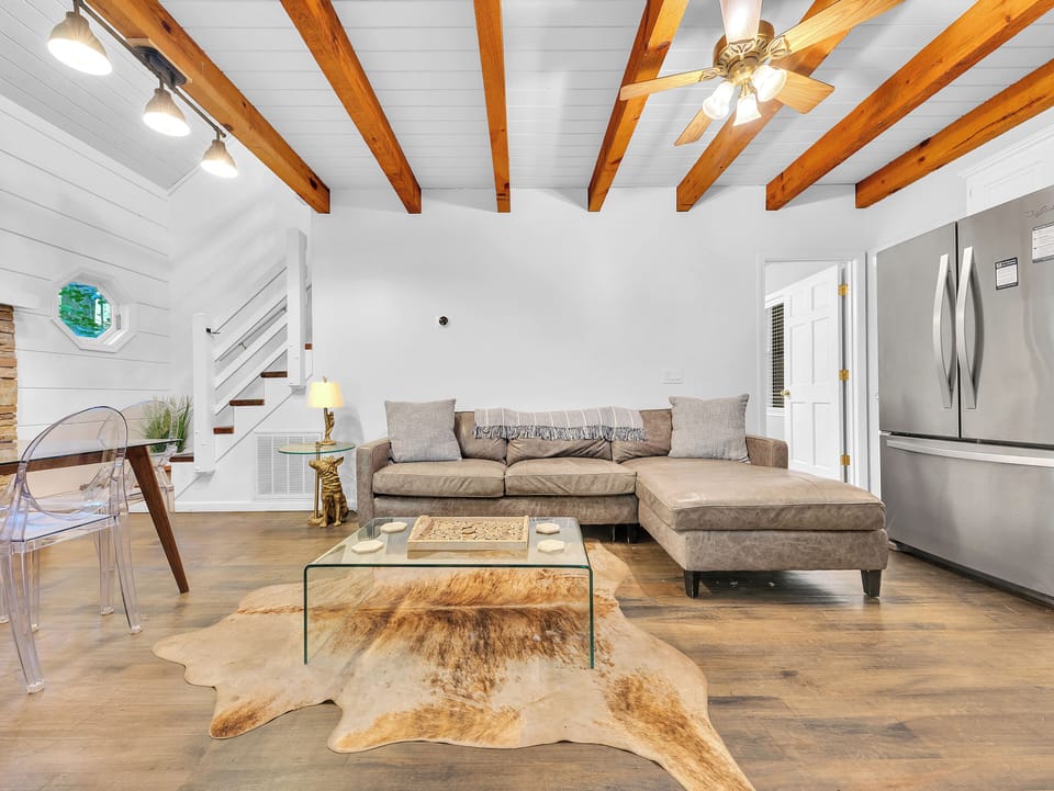 The cabin's living room and dining area offer the perfect space for gathering with friends and family.