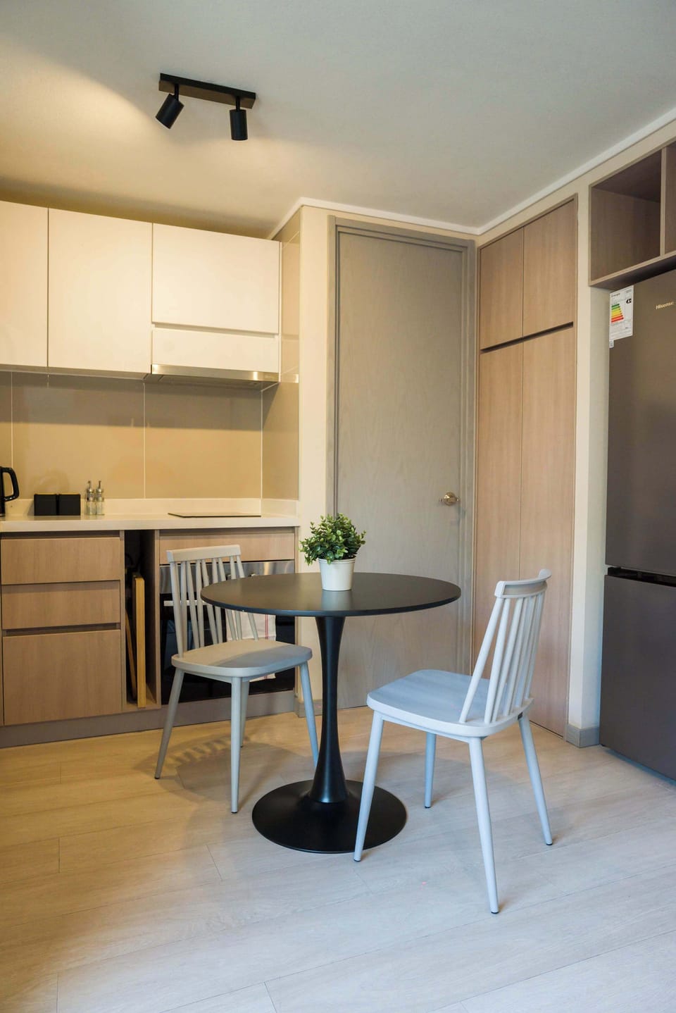 Cozy kitchen with modern amenities and a charming dining area, perfect for intimate meals.