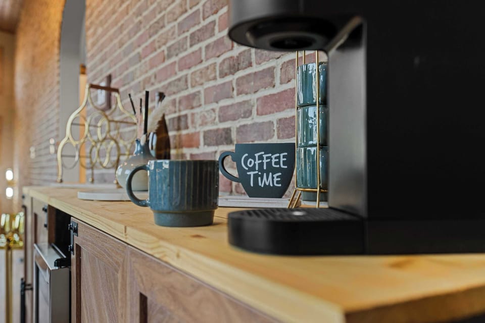 Coffee Corner, enjoy your morning brew surrounded by charming brick decor and stylish accents!