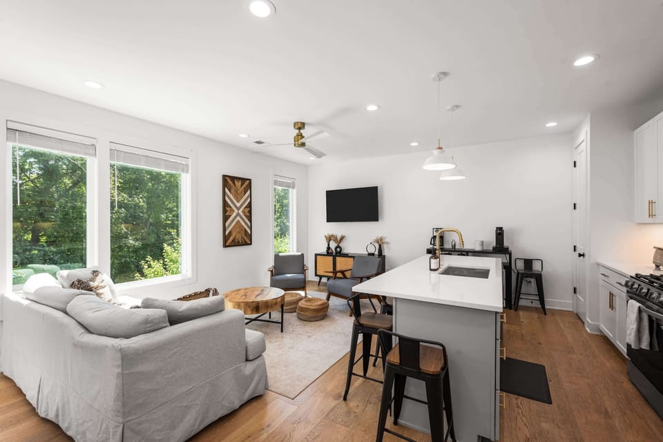 Bright, open living space with smart TV and queen sleeper sofa