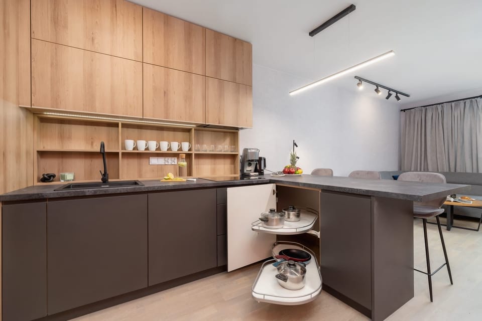 The sleek design of the kitchenette blending seamlessly with the living area.