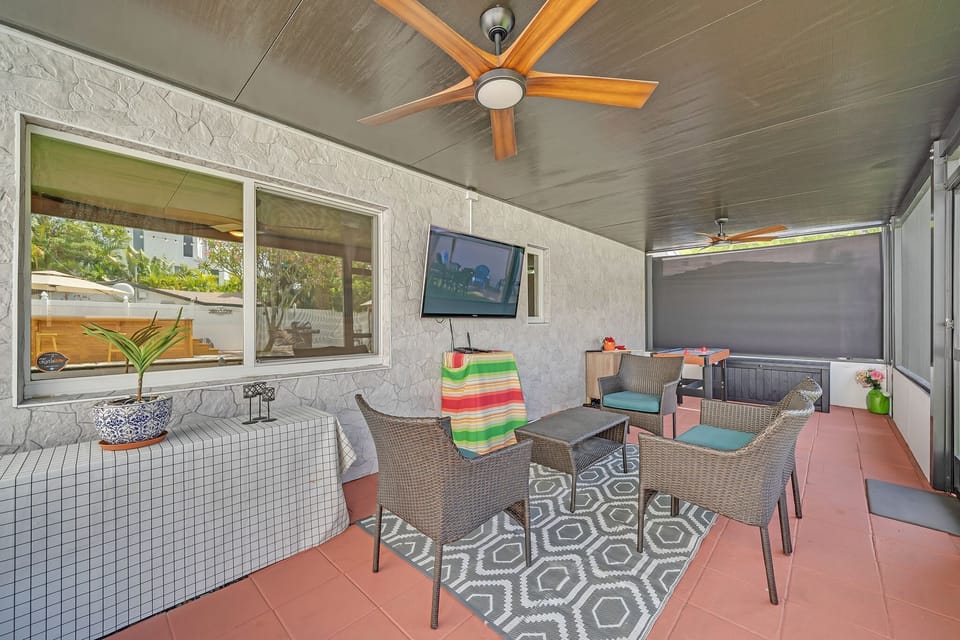 Screened in patio with outdoor seating and Smart TV