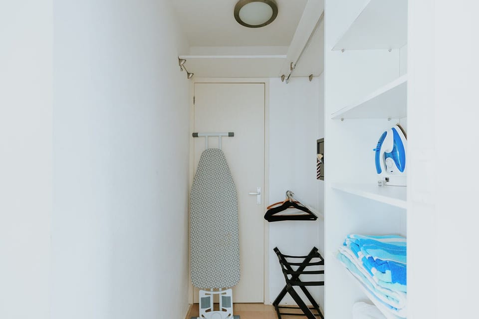 Your vacation wardrobe stays fresh with a dedicated ironing board, folding rack, and organized shelving—everything you need to look your best during your stay.