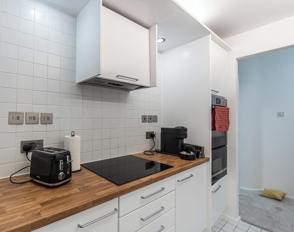 KITCHEN WITH COOKING ESSENTIALS AND DISHWASHER
