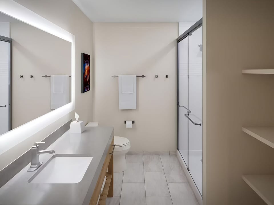 Refresh easily with bright vanity mirror and walk-in shower.