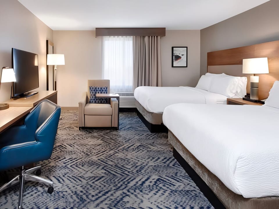 Stretch out with roomy layout, big TV, and work desk.