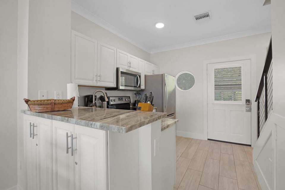 Full kitchen and front door to the villa