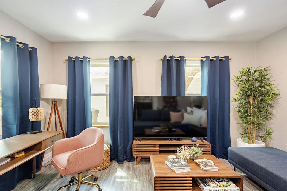 Living room with 65" smart tv, workspace and queen sleeper