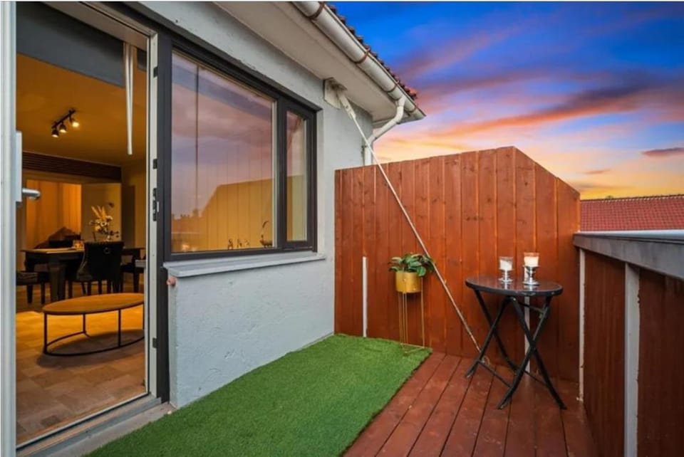 Cozy balcony with sunset views, cityscapes, fresh air, and warm evening ambiance