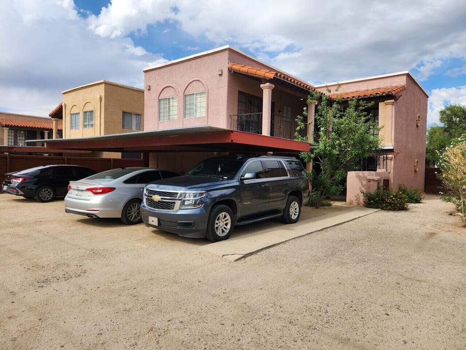Covered assigned parking with cameras and motion-activated security lights.