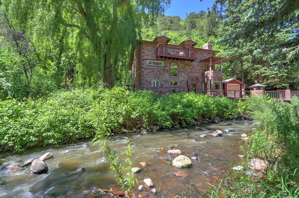 Summertime view of creek and house