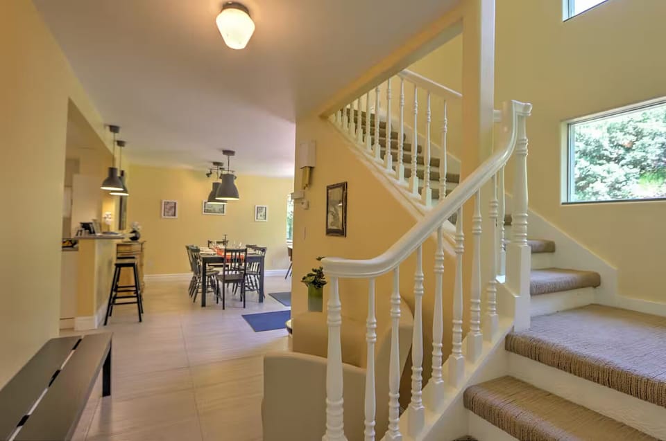 Window-lined stairwell to second level seating area and bedrooms
