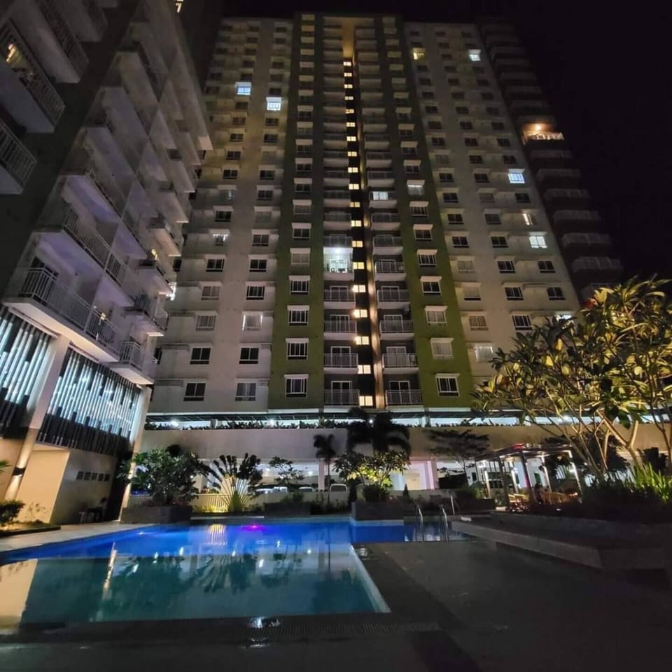 Night view of the condo with beautifully lit pool