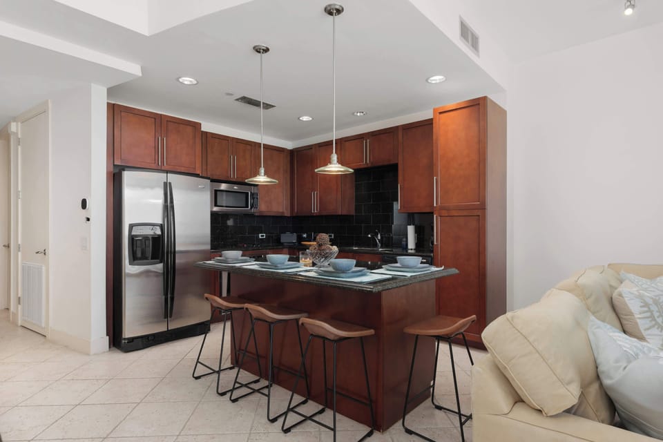A warm, open kitchen space with simple styling, natural tones, and an easy flow that feels relaxed and welcoming. The clean layout and calm atmosphere make it a comfortable spot to gather, share meals, and enjoy unhurried moments throughout the stay.
