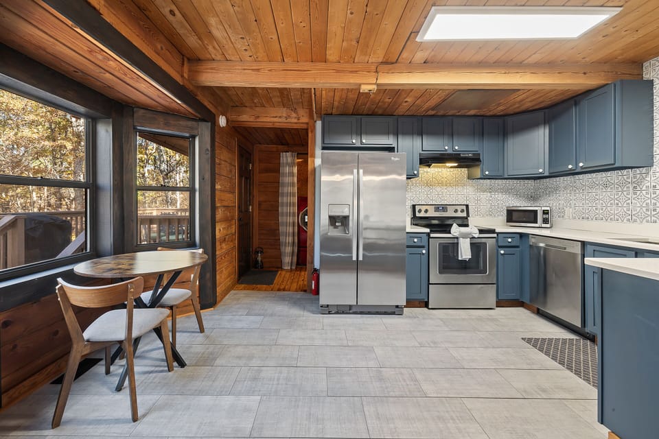 Kitchen open to dining, deck access