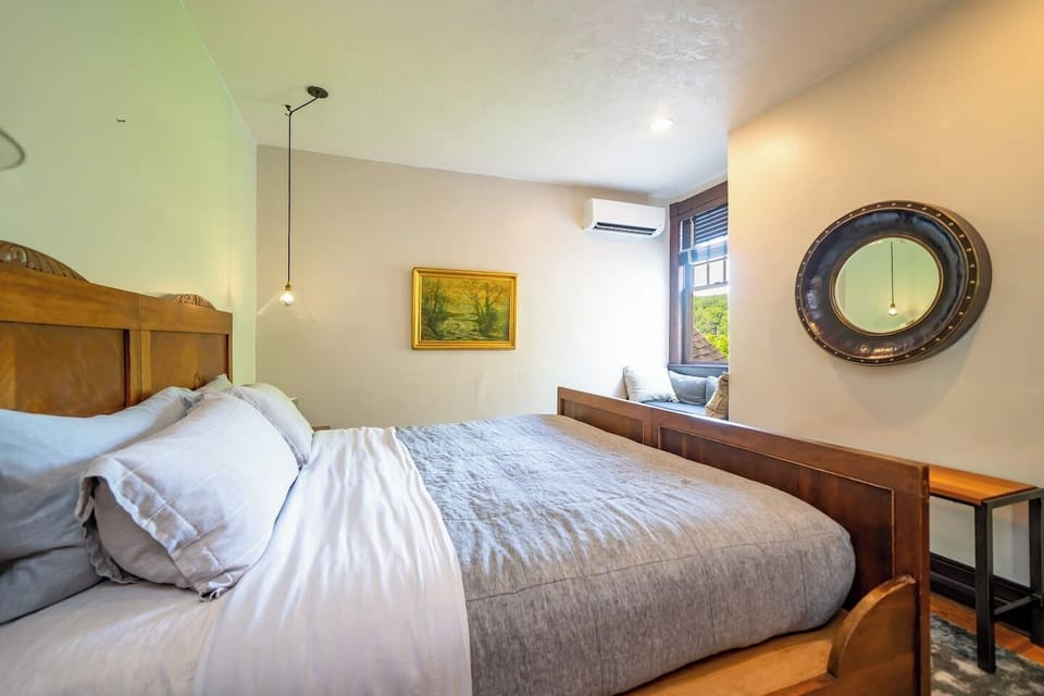 Bedroom #5 (second floor) with a king bed and a full bathroom shared with room #6. The bathroom is accessed through a short hallway that's shared with room #6.