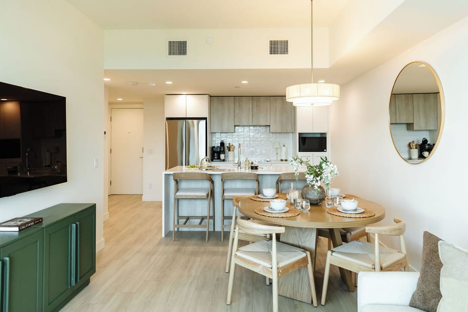 Modern open-concept apartment with seamless flow between living, dining, and kitchen