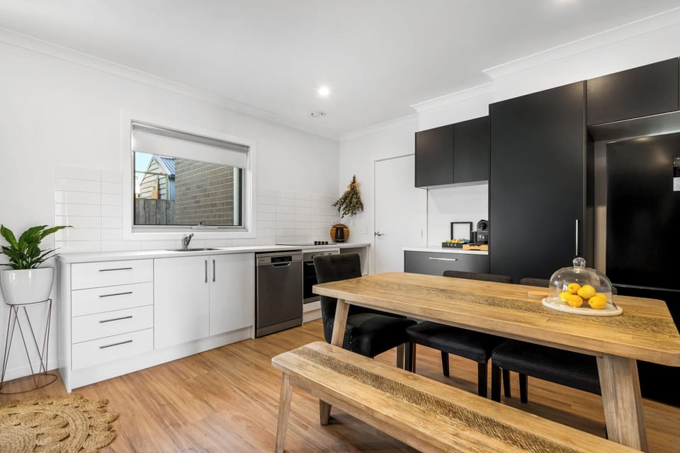 Open plan kitchen featuring stainless steel appliances and coffee pod machine. 