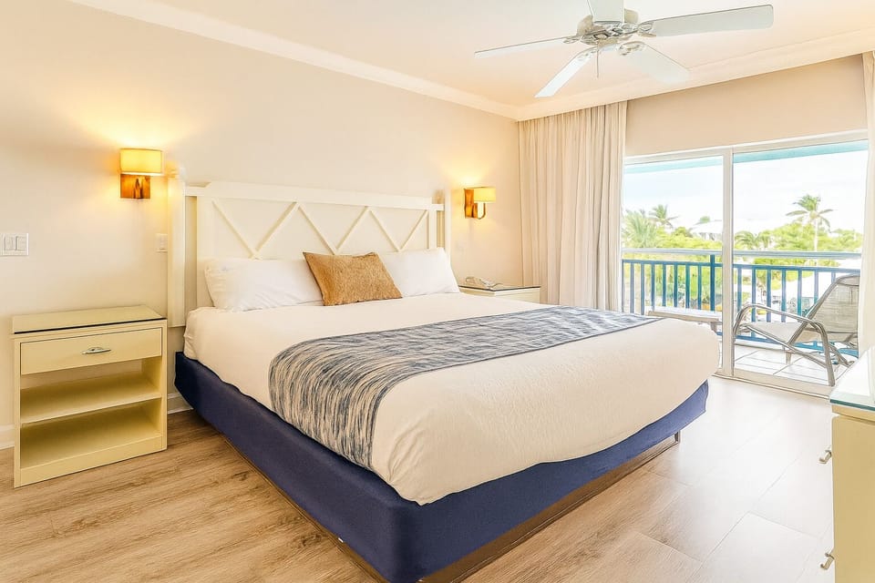 Start your morning with sunshine and balcony breezes by the bed.