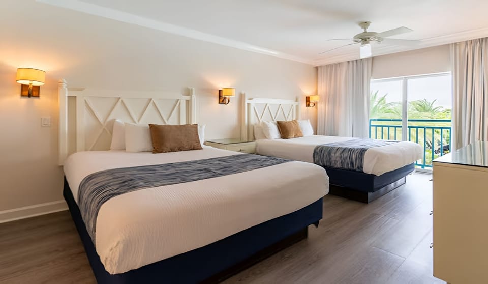 Stretch out in a serene room framed by tropical views.