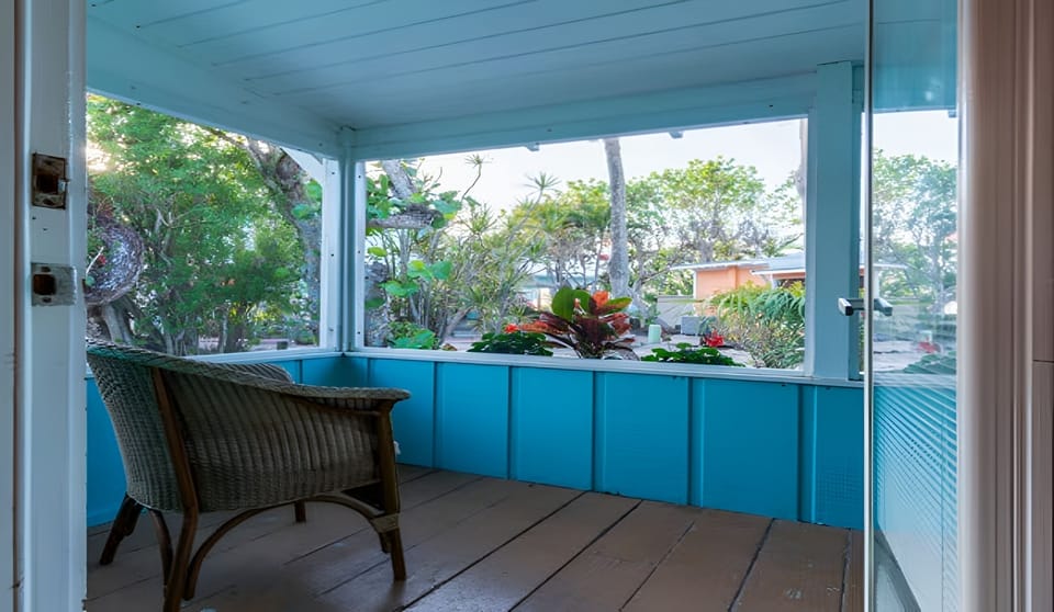 Linger outside in shaded seating surrounded by tropical greenery.