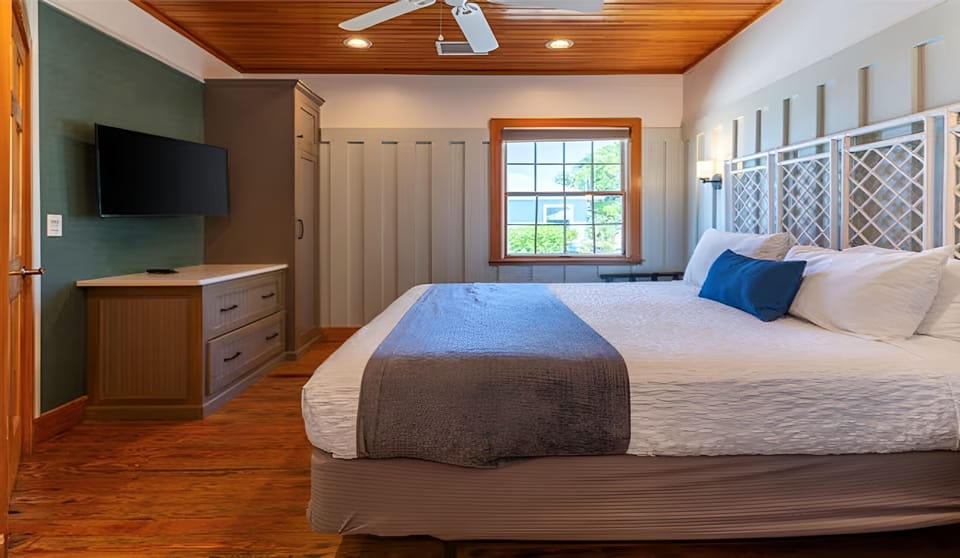 Recharge in a sunlit king bedroom with serene coastal style.