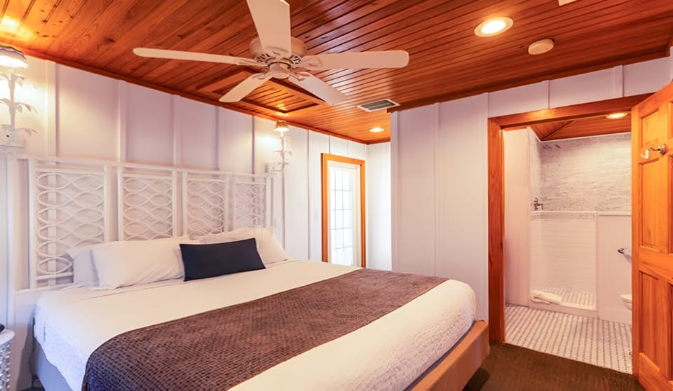 Sink into crisp linens beneath warm wood ceilings and fans.