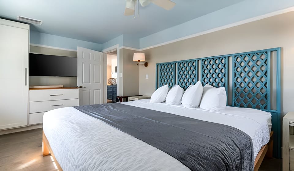 Sink into a spacious king bed under soft, breezy light.