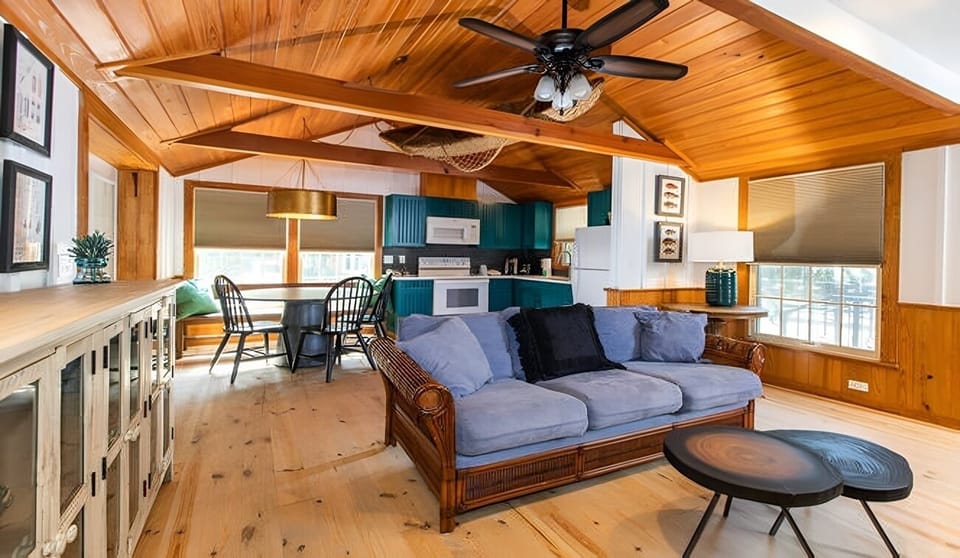 Gather on the cozy sofa in this bright open-concept space.
