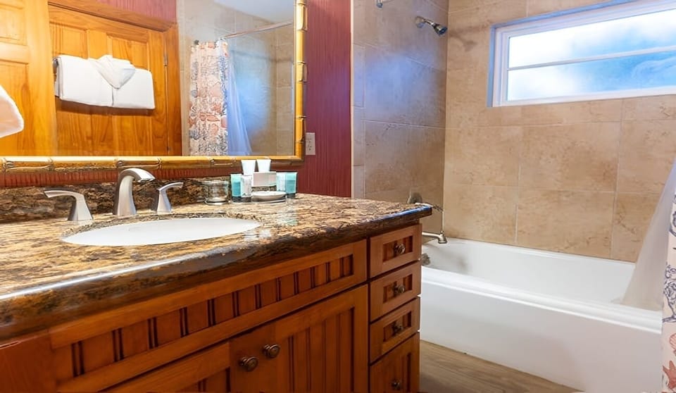 Indulge in a bright bath with granite vanity and tub.