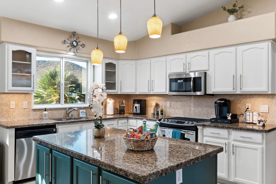 Fully equipped kitchen with large island, modern appliances & mountain views
