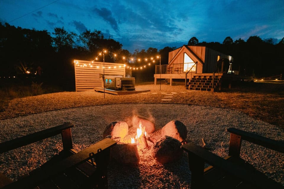 The backyard is beautifully illuminated with a fire pit, hot tub, dining area and great views!
